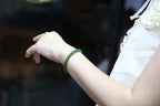 PILLAR Pill 6×5 · Spinach Green — nephrite jade cylinder bracelet, on the hand