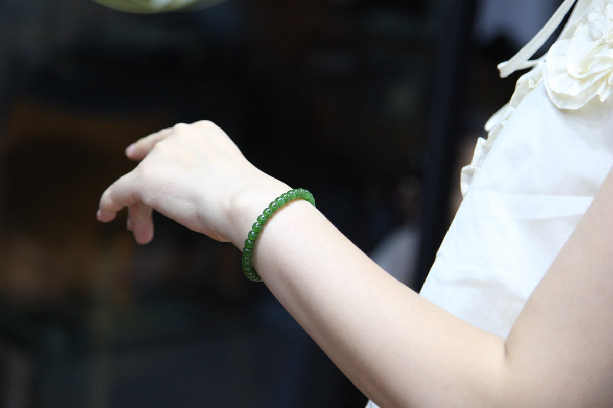 PILLAR Pill 6×5 · Spinach Green — nephrite jade cylinder bracelet, on the hand
