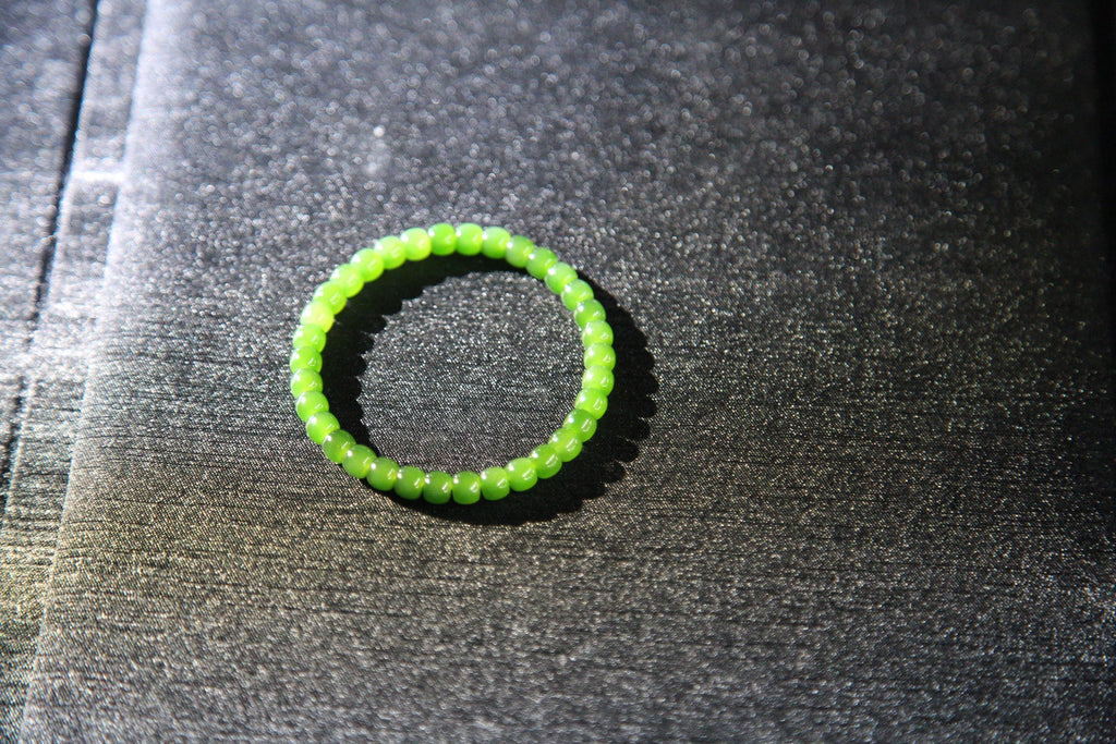 PILLAR Pill 6×5 · Spinach Green — nephrite jade cylinder bracelet, on the model