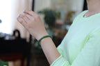 PILLAR Pill 7×6 · Willow Green — nephrite jade cylinder bracelet, on the wrist