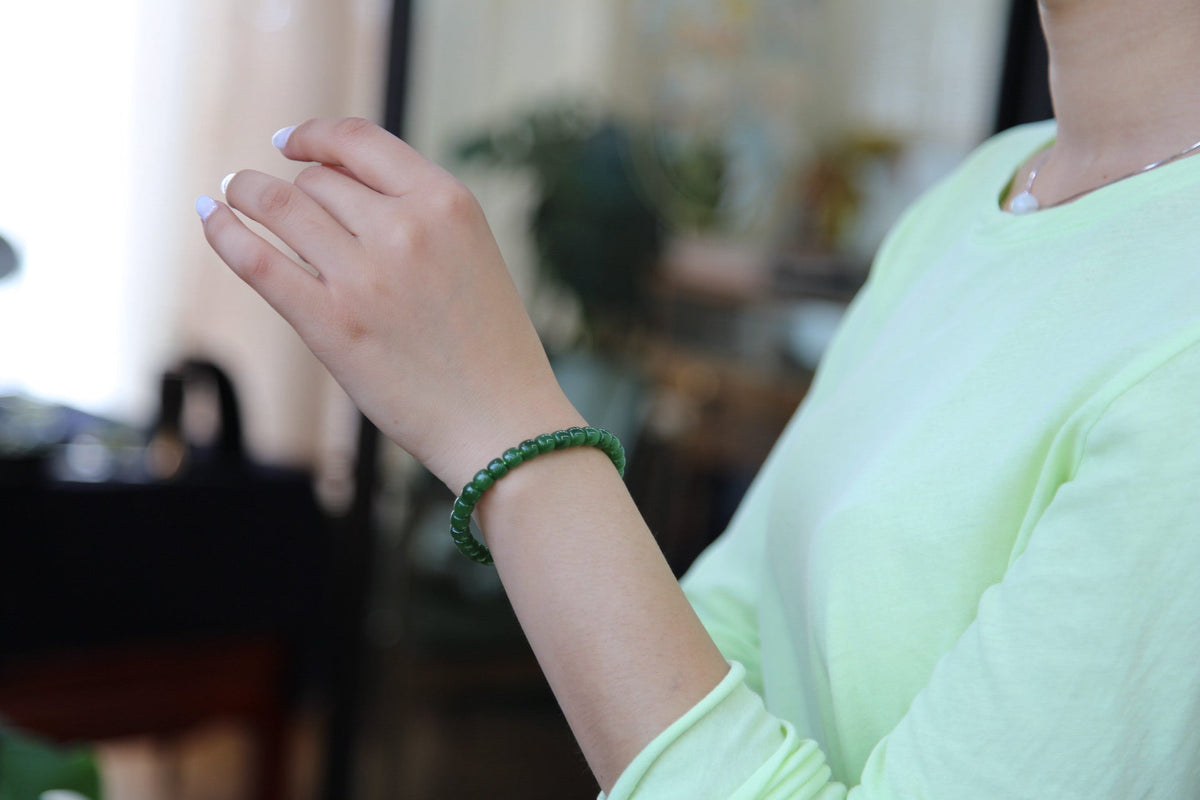 PILLAR Pill 7×6 · Willow Green — nephrite jade cylinder bracelet, on the wrist