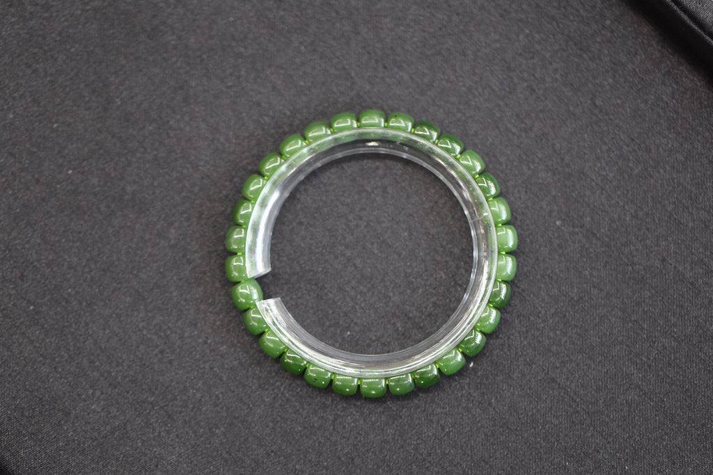 PILLAR Pill 7×6 · Willow Green — nephrite jade cylinder bracelet, on the model