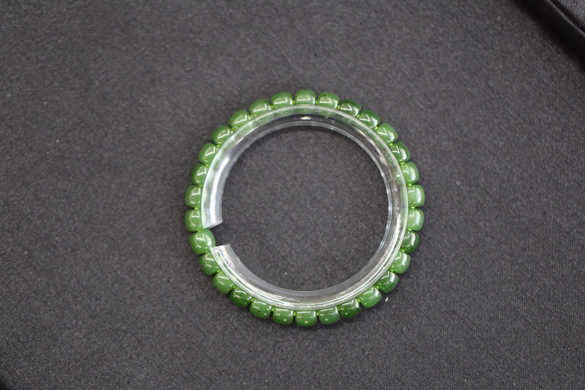 PILLAR Pill 7×6 · Willow Green — nephrite jade cylinder bracelet, on the model