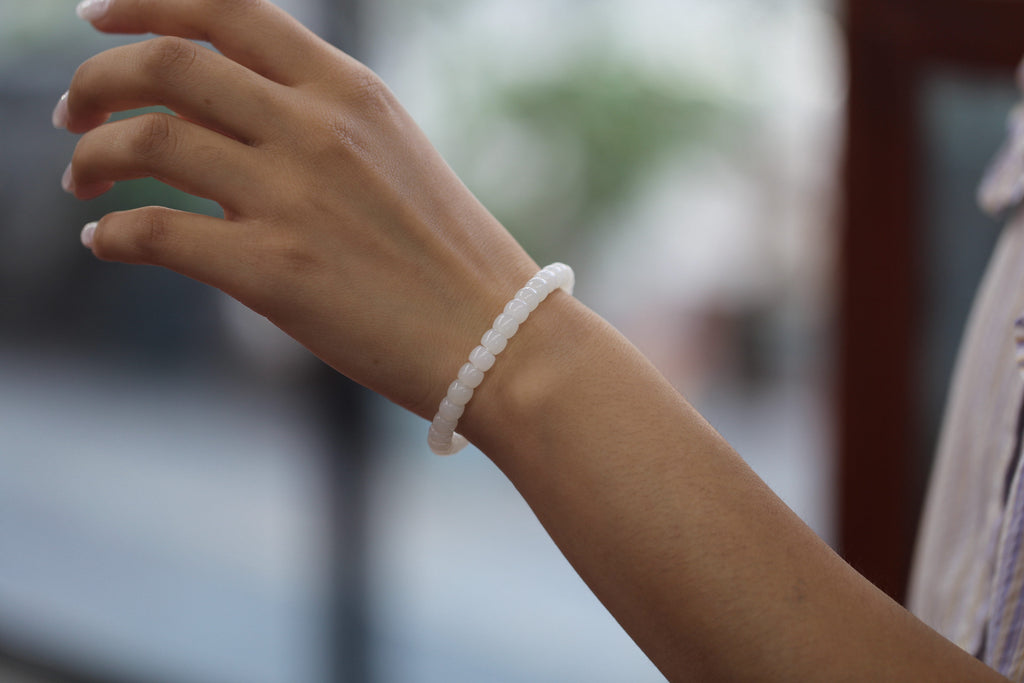 PILLAR Pill 6.7×5 · Suet White 1 — nephrite jade cylinder bracelet, on the hand