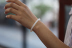 PILLAR Pill 6.7×5 · Suet White 1 — nephrite jade cylinder bracelet, on the hand