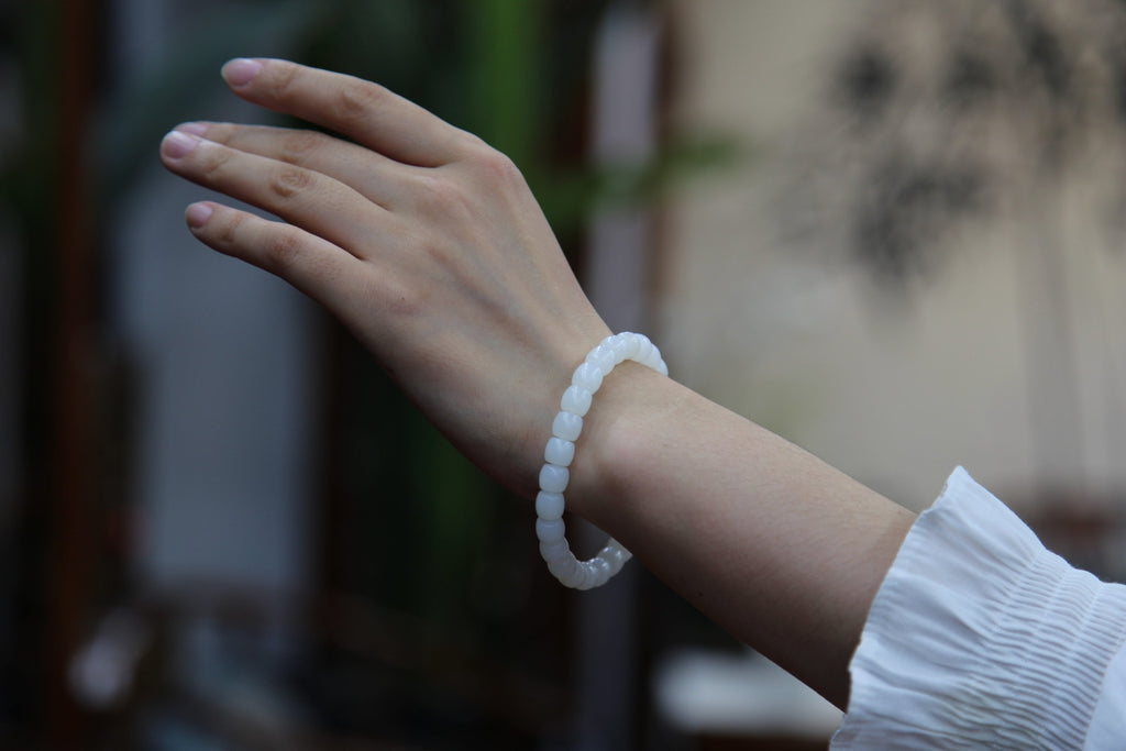 PILLAR Pill 7.8×7.2 · Suet White — nephrite jade cylinder bracelet, on the wrist