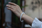 PILLAR Pill 7.8×7.2 · Suet White — nephrite jade cylinder bracelet, on the wrist