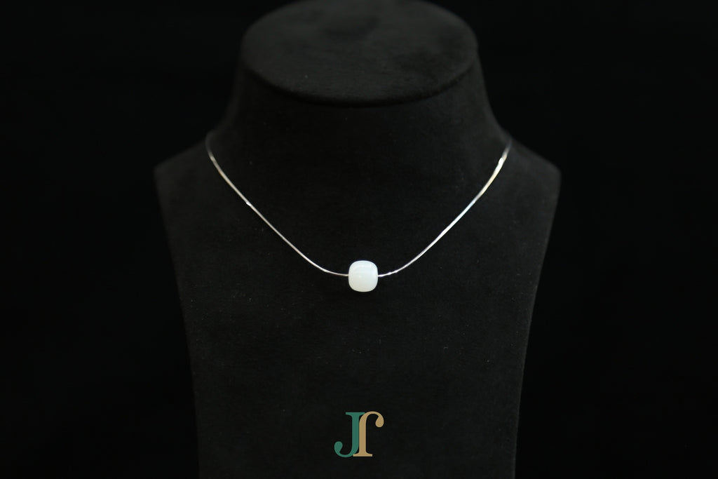 PILLAR Pure 10×9 · Suet White — nephrite jade cylinder necklace, on a display bust