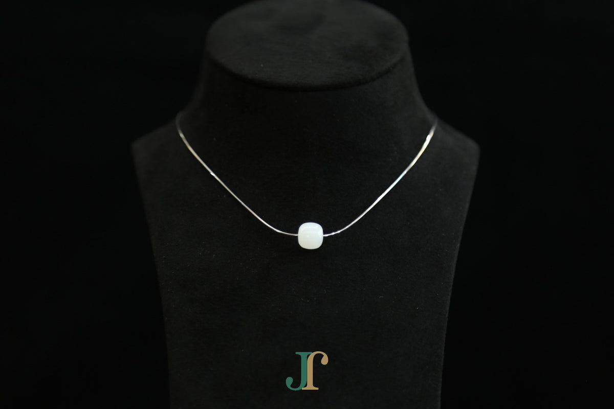 PILLAR Pure 10×9 · Suet White — nephrite jade cylinder necklace, on a display bust
