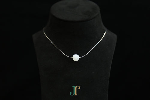 PILLAR Pure 10×9 · Suet White — nephrite jade cylinder necklace, on a display bust