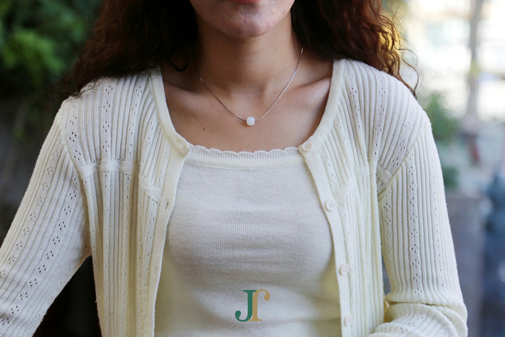 PILLAR Pure 10×9 · Suet White — nephrite jade cylinder necklace, worn