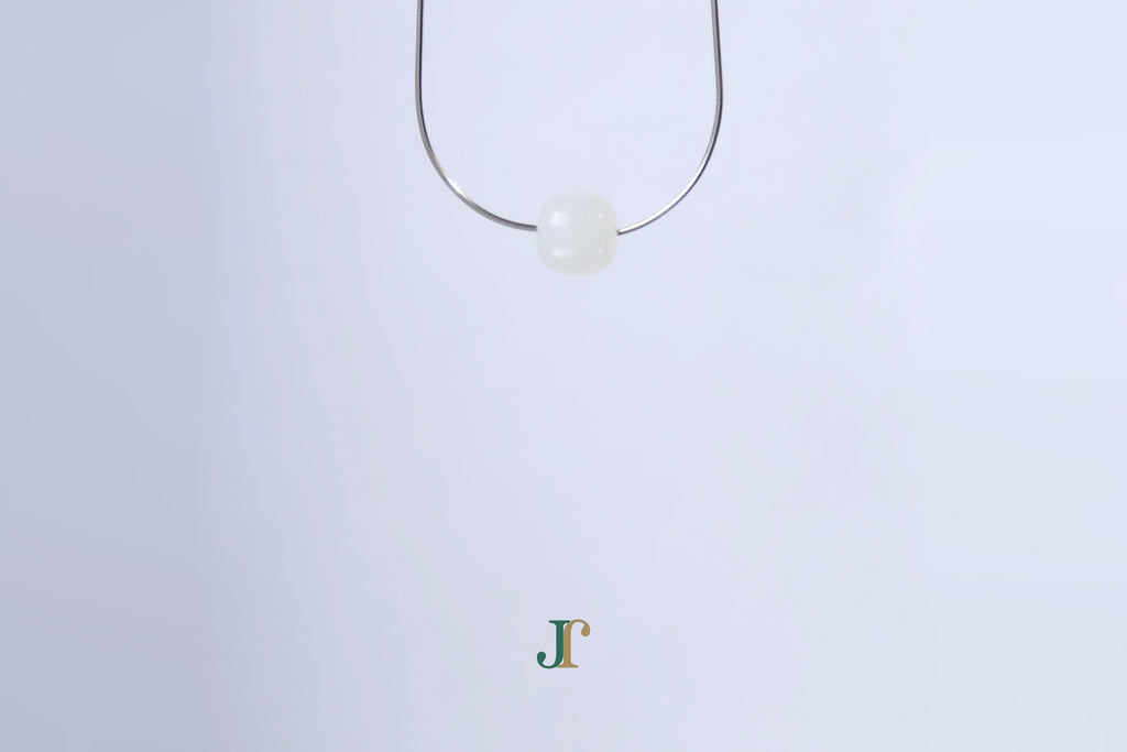 PILLAR Pure 10×9 · Suet White — nephrite jade cylinder necklace, hanging