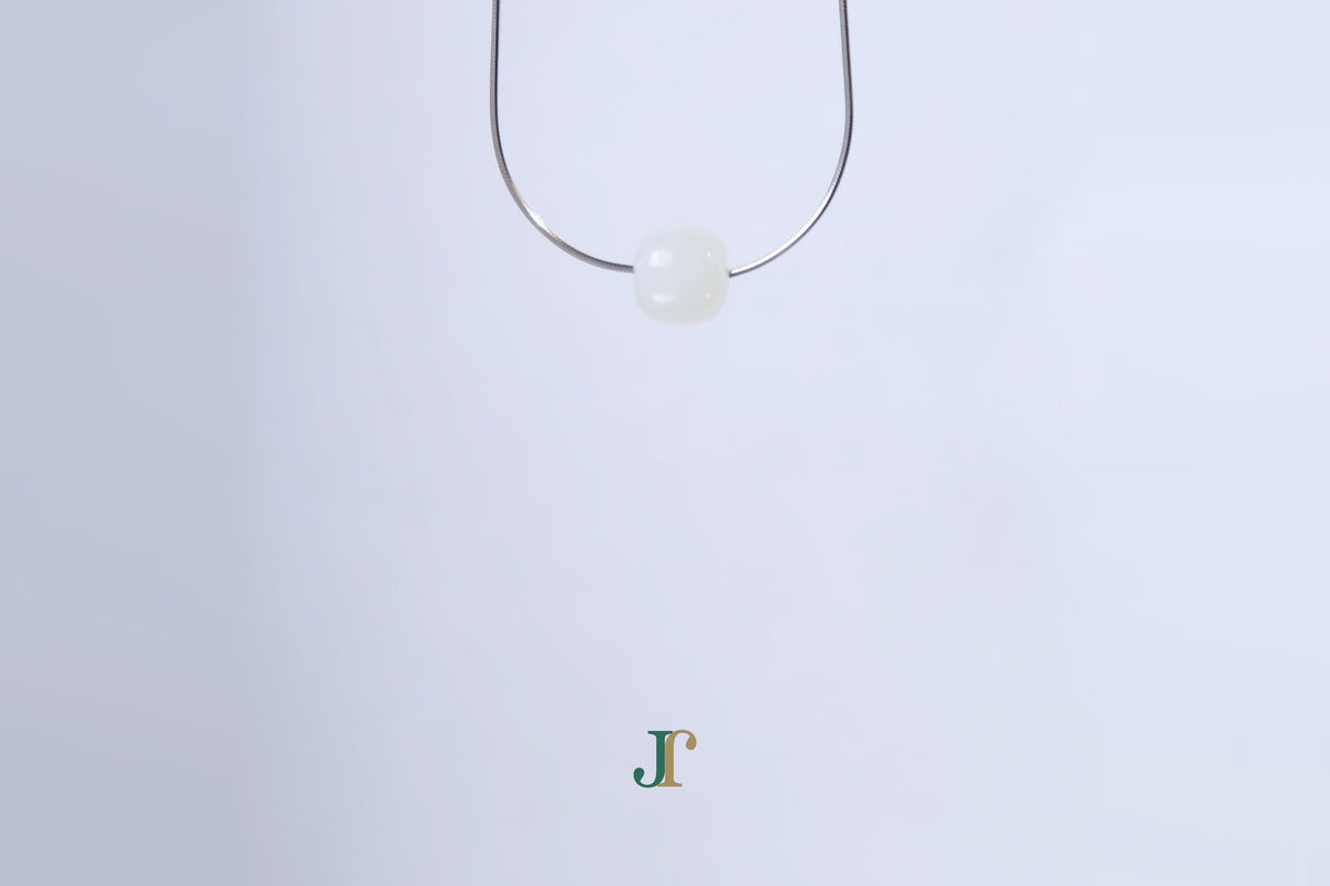 PILLAR Pure 10×9 · Suet White — nephrite jade cylinder necklace, hanging