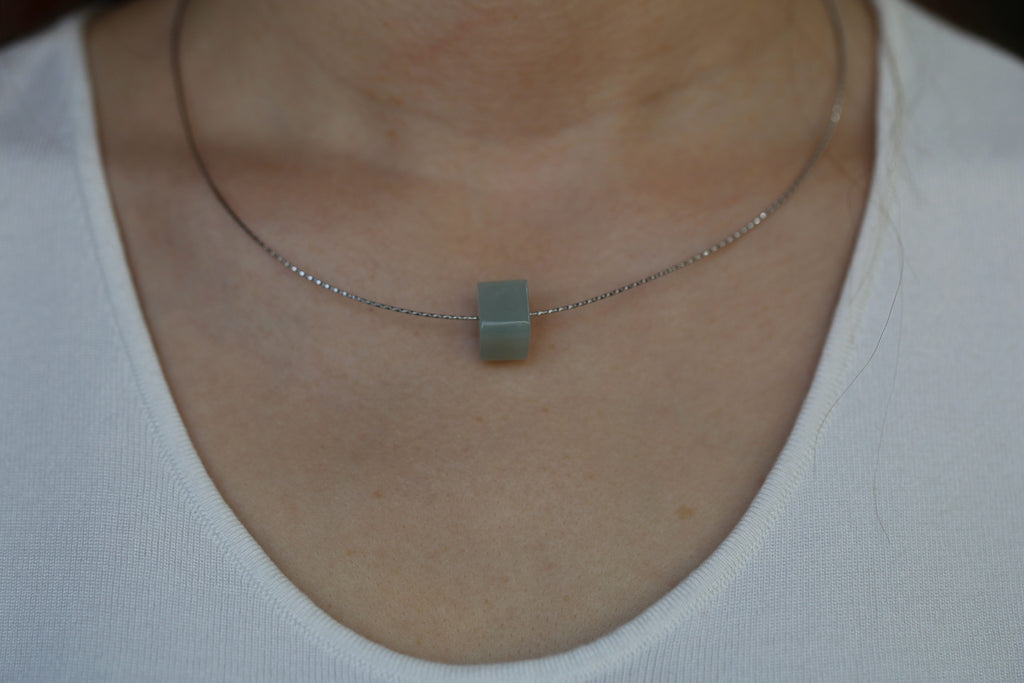 PILLAR Pure 12×9.5 · Willow Green — nephrite jade pendant, on the model