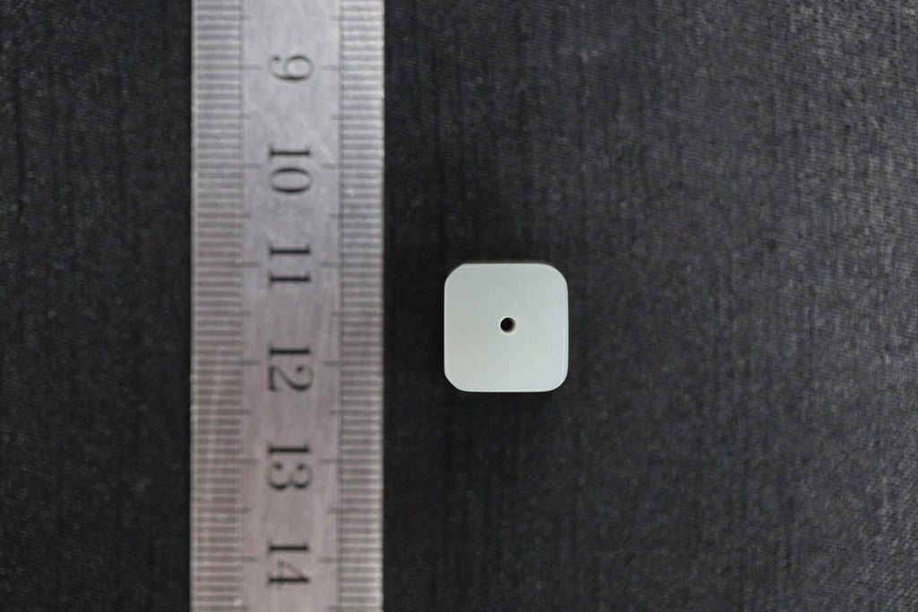 PILLAR Pure 12×9.5 · Willow Green — nephrite jade pendant, with a ruler for scale