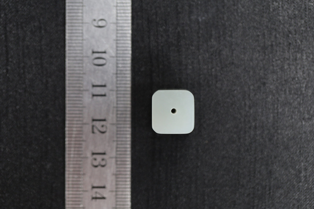 PILLAR Pure 12×9.5 · Willow Green — nephrite jade pendant, with a ruler for scale