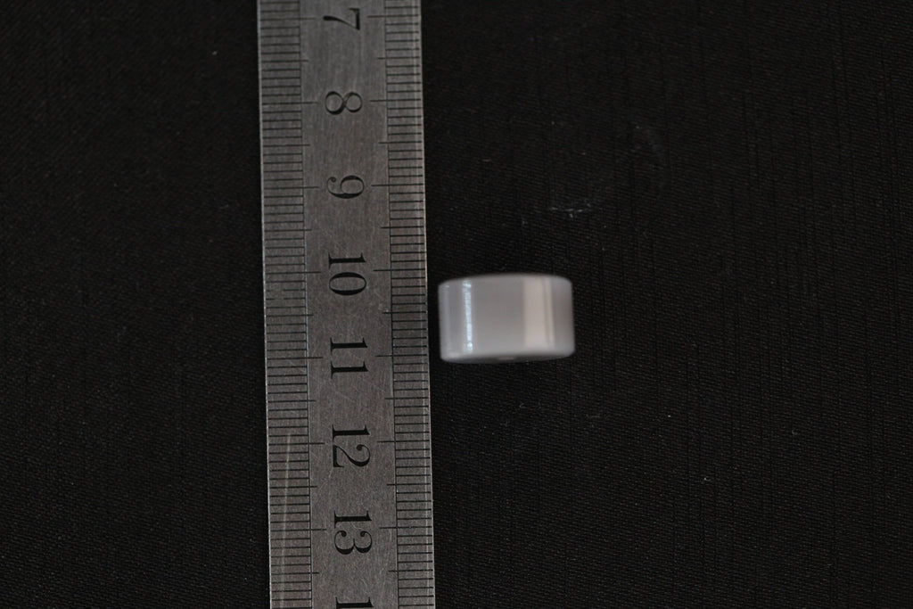 PILLAR Pure 15×9 · Smoky Lilac — nephrite jade pendant, with a ruler for scale