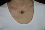 PILLAR Pure 16×12 · Multi-Colour — nephrite jade pendant, worn, close-up