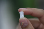 PILLAR Pure 6×12 · Suet White — nephrite jade cylinder necklace, in the hand