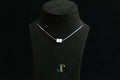 PILLAR Pure 6×12 · Suet White — nephrite jade cylinder necklace, on a display bust