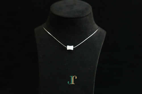 PILLAR Pure 6×12 · Suet White — nephrite jade cylinder necklace, on a display bust
