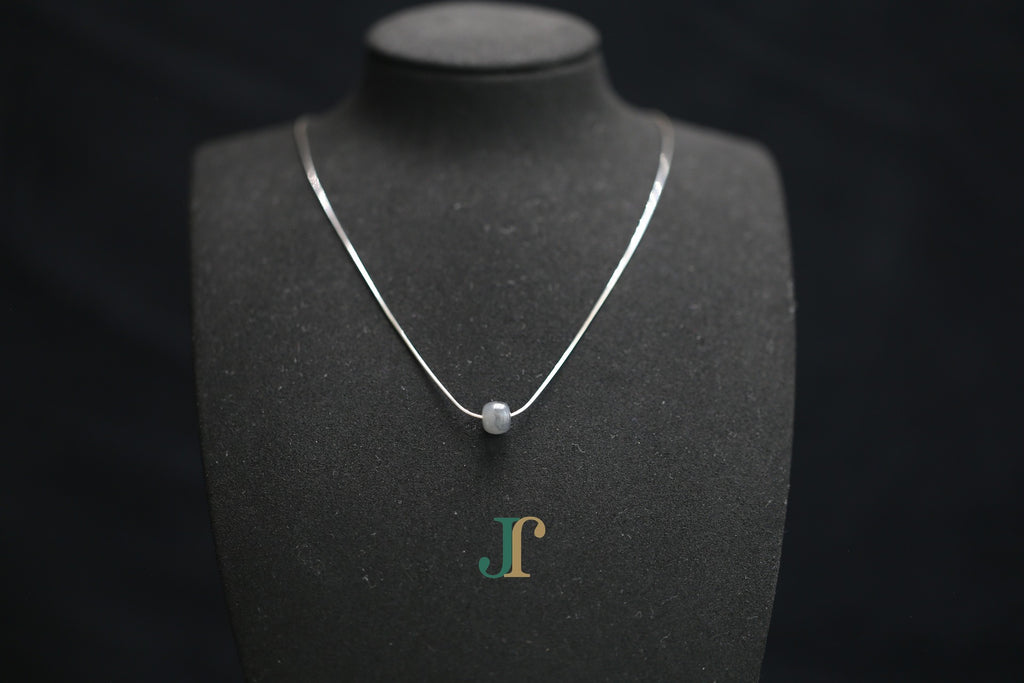 PILLAR Pure 7×6 · Ink Wash — nephrite jade cylinder necklace, on a display bust
