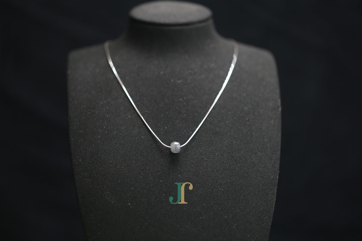 PILLAR Pure 7×6 · Ink Wash — nephrite jade cylinder necklace, on a display bust