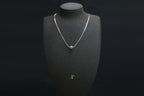 PILLAR Pure 7×6 · Spinach Green — nephrite jade cylinder necklace, on a display bust