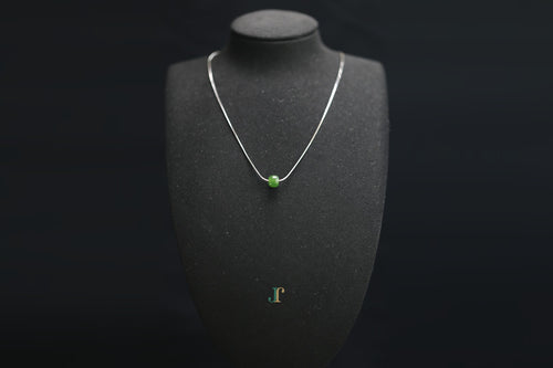 PILLAR Pure 7×6 · Spinach Green — nephrite jade cylinder necklace, on a display bust