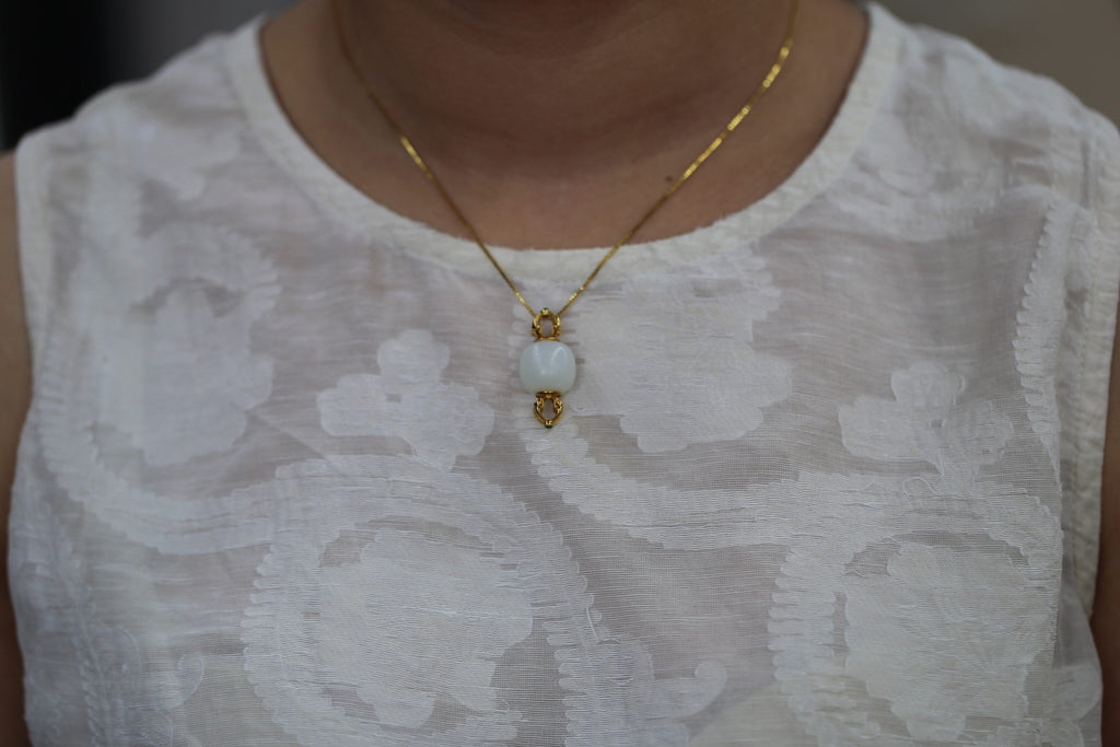 PILLAR Roller 13×14 · Suet White — nephrite jade pendant, on the model