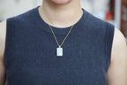 TABULA 001 · Suet White — nephrite jade pendant, on the hand
