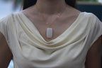 TABULA 002 · Suet White — nephrite jade pendant, on the hand