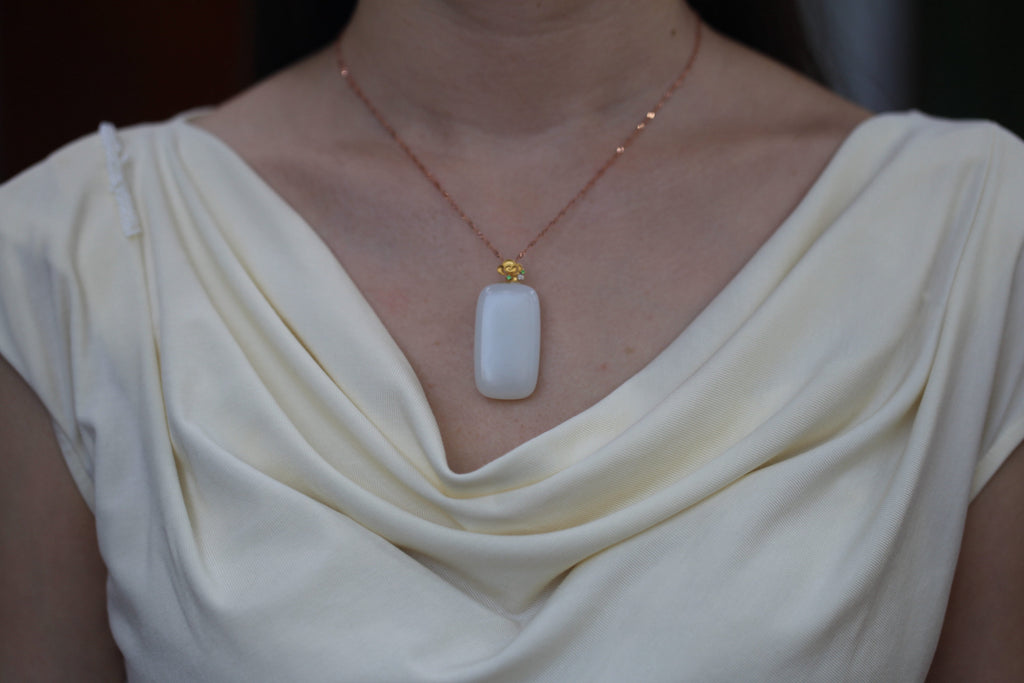 TABULA 002 · Suet White — nephrite jade pendant, on the model