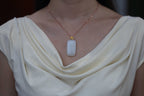 TABULA 002 · Suet White — nephrite jade pendant, on the model