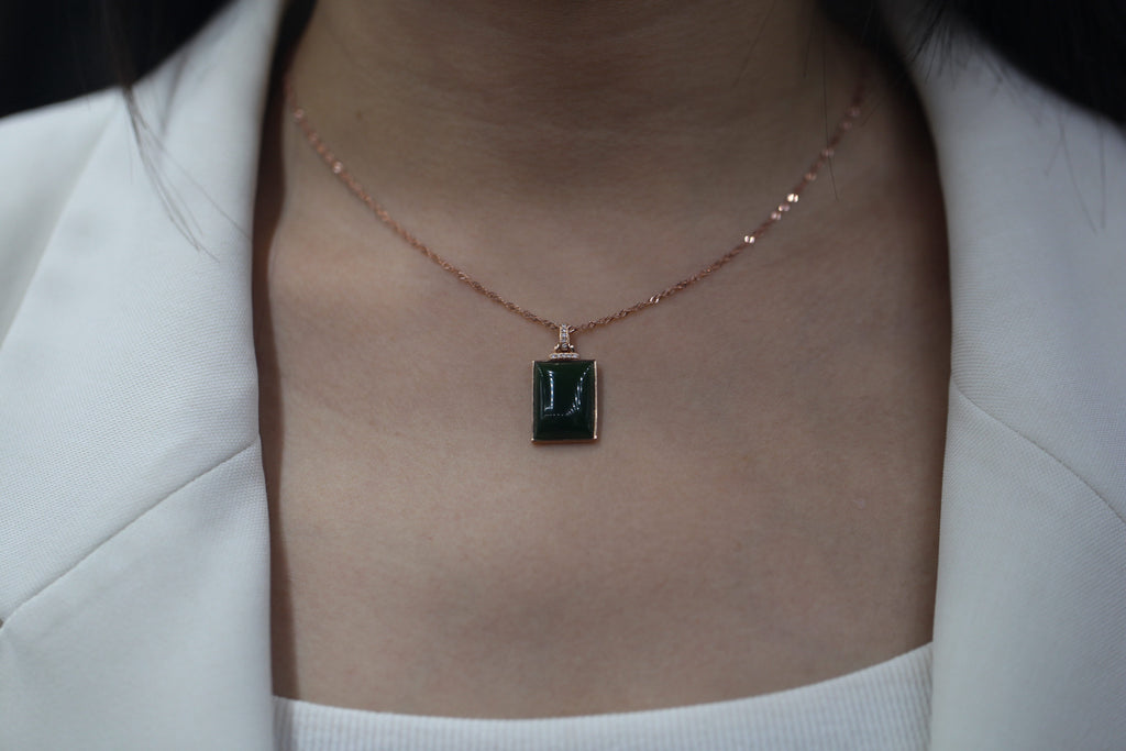 TABULA 003 · Spinach Green — nephrite jade pendant, on the hand