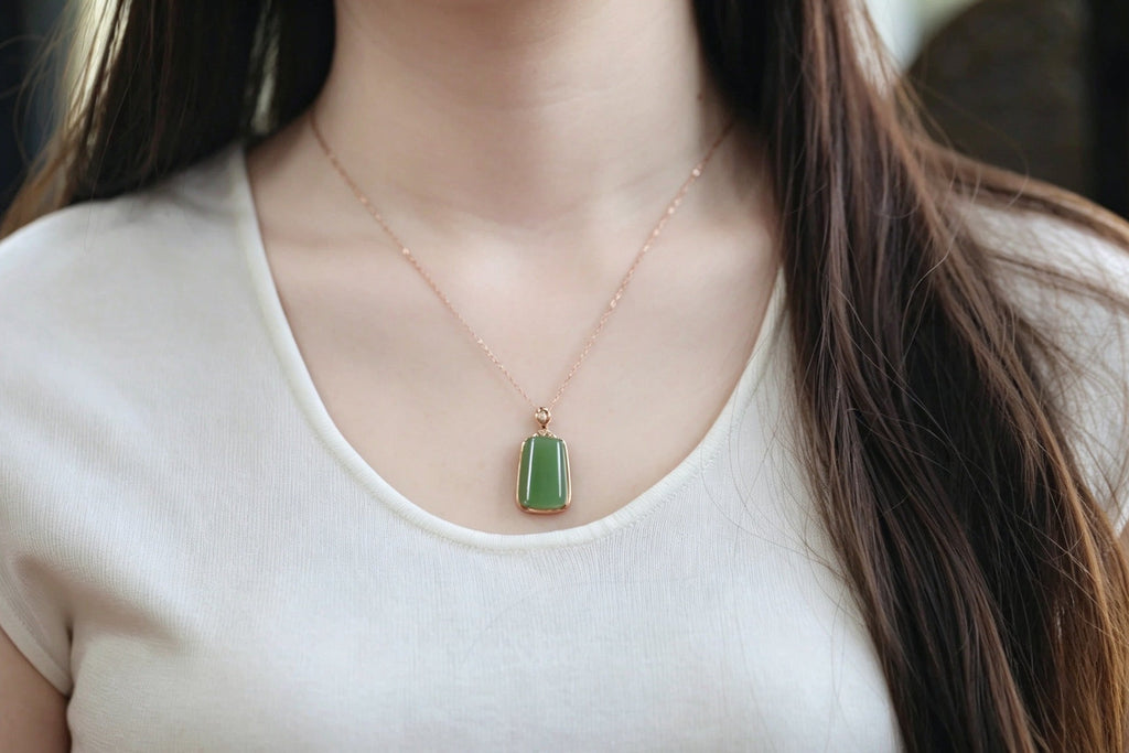 TABULA 004 · Willow Green — nephrite jade pendant, on the hand