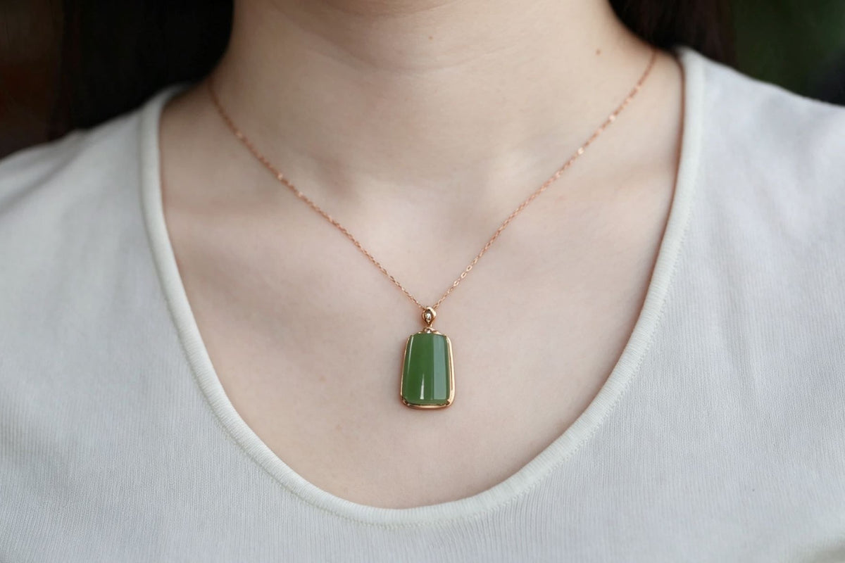 TABULA 004 · Willow Green — nephrite jade pendant, on the model