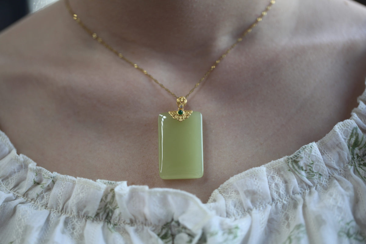 TABULA 008 · Golden Green — nephrite jade pendant, on the hand