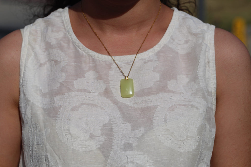 TABULA 009 · Golden Green — nephrite jade pendant, on the model, close