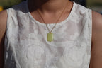 TABULA 009 · Golden Green — nephrite jade pendant, on the model