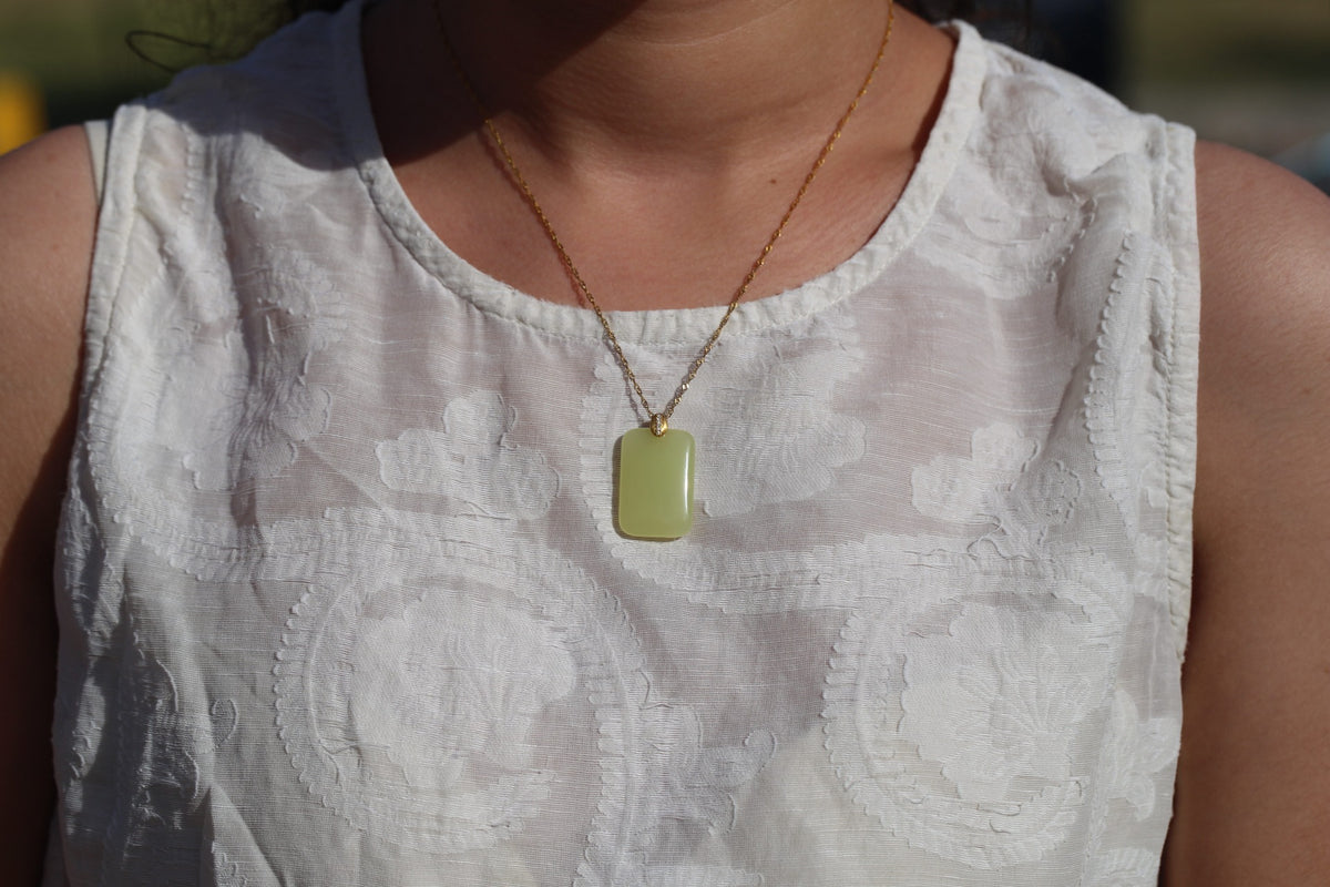 TABULA 009 · Golden Green — nephrite jade pendant, on the model