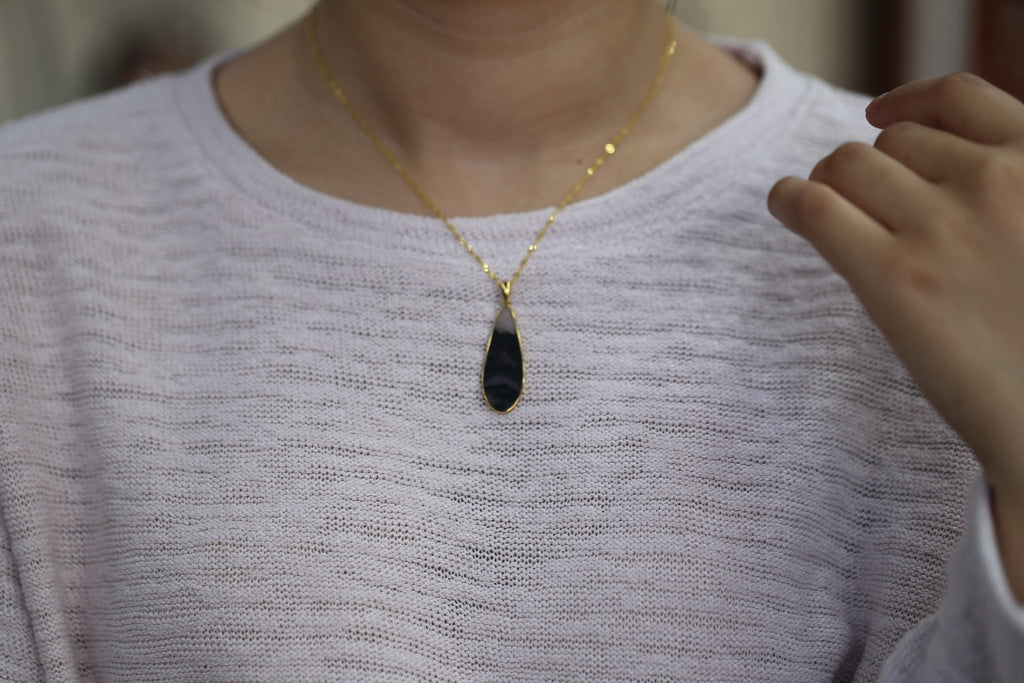 TABULA 016 · Ink Wash — nephrite jade pendant, on the model