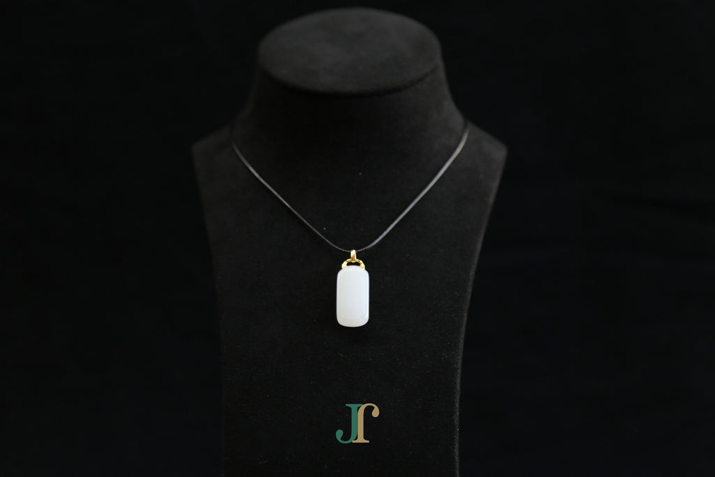 TABULA 018 · Suet White — nephrite jade pendant, on a display bust