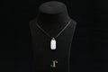 TABULA 018 · Suet White — nephrite jade pendant, on a display bust