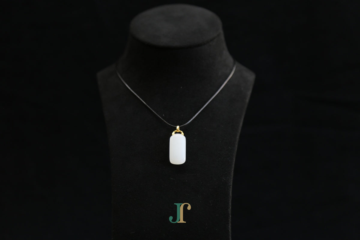 TABULA 018 · Suet White — nephrite jade pendant, on a display bust