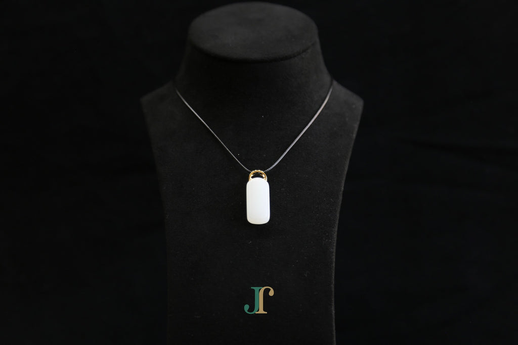 TABULA 019 · Suet White — nephrite jade pendant, on a display bust