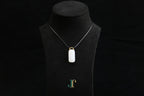 TABULA 019 · Suet White — nephrite jade pendant, on a display bust