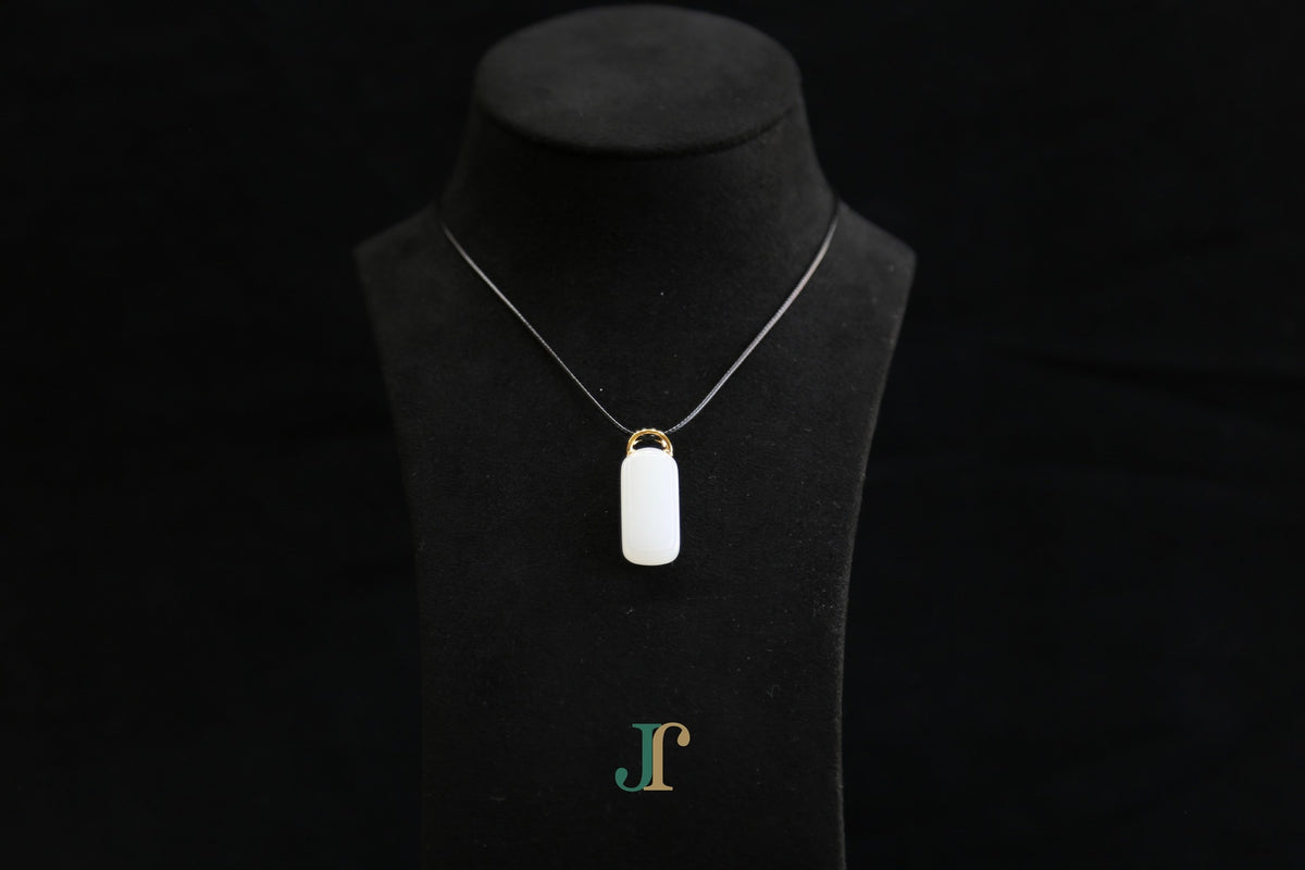 TABULA 019 · Suet White — nephrite jade pendant, on a display bust