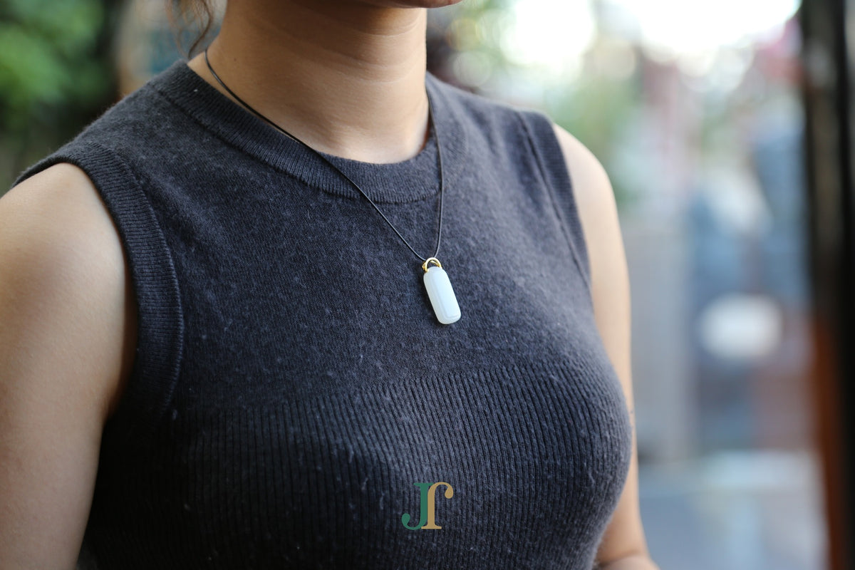 TABULA 019 · Suet White — nephrite jade pendant, worn, second view
